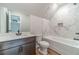 Bathroom with marble tile accents, vanity with solid surface counter, and hardwood floors at 1482 Alcovy Station Rd, Covington, GA 30014