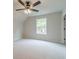 Neutral bedroom boasting a ceiling fan and a large window at 1482 Alcovy Station Rd, Covington, GA 30014