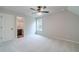 Bright bedroom features neutral walls, plush carpeting, and an adjoining bathroom with dark wood cabinets at 1482 Alcovy Station Rd, Covington, GA 30014
