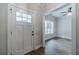 Inviting foyer with wood-look flooring, a white door, and an entryway to a naturally lit living space at 1482 Alcovy Station Rd, Covington, GA 30014