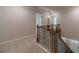 Upstairs hallway featuring carpet, white trim, and decorative dark iron balusters at 1482 Alcovy Station Rd, Covington, GA 30014