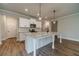 Spacious kitchen with an island, pendant lighting, stainless appliances, and white cabinetry at 1482 Alcovy Station Rd, Covington, GA 30014