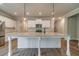 Bright kitchen featuring a large island with white cabinets, perfect for meal prep and entertaining at 1482 Alcovy Station Rd, Covington, GA 30014