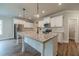 Gourmet kitchen featuring stainless steel appliances, a large island, and sleek white cabinetry at 1482 Alcovy Station Rd, Covington, GA 30014