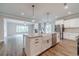 Open-concept kitchen with granite counters, a farmhouse sink, stainless appliances, and wood-look floors at 1482 Alcovy Station Rd, Covington, GA 30014