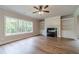 Living room with a fireplace, built-in shelves and cabinets, plus a ceiling fan with lights at 1482 Alcovy Station Rd, Covington, GA 30014