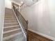 Carpeted staircase with decorative wood and iron railing at 1482 Alcovy Station Rd, Covington, GA 30014