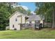 View of the backyard featuring a wood deck, a well-maintained lawn and a lush tree line at 309 Carmen Ct, Lawrenceville, GA 30046