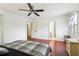 Spacious bedroom with hardwood floors, ceiling fan, and neutral colors, offering a serene and relaxing retreat for rest and rejuvenation at 309 Carmen Ct, Lawrenceville, GA 30046