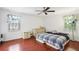 Bright bedroom with hardwood floors, two windows, and a ceiling fan, creating a comfortable and relaxing space for restful nights at 309 Carmen Ct, Lawrenceville, GA 30046