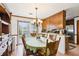 Dining area with a wooden table and chairs, sliding glass doors to the outside, and a decorative chandelier, perfect for Gathering gatherings at 309 Carmen Ct, Lawrenceville, GA 30046