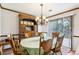 Classic dining area with wood furniture, decorative chandelier, and sliding glass doors, ideal for entertaining guests or enjoying Gathering meals at 309 Carmen Ct, Lawrenceville, GA 30046