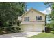Charming home with a two-car garage, well-kept lawn, and mature trees adding curb appeal at 309 Carmen Ct, Lawrenceville, GA 30046