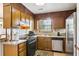Functional kitchen featuring stainless steel appliances, wooden cabinets, and granite countertops, creating an efficient cooking space at 309 Carmen Ct, Lawrenceville, GA 30046