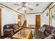 Comfortable living room with a ceiling fan, staircase access, and classic wood trim, perfect for relaxing and entertaining guests at 309 Carmen Ct, Lawrenceville, GA 30046