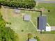 Aerial view of a large, fenced property with a well-maintained lawn, outbuilding, and playhouse at 3872 Francis Dr, Powder Springs, GA 30127