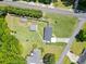 Expansive fenced property featuring a well-maintained lawn, outbuilding, and a charming playhouse at 3872 Francis Dr, Powder Springs, GA 30127