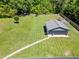 A spacious fenced lot featuring a well-kept lawn, detached garage, and charming playhouse, perfect for families at 3872 Francis Dr, Powder Springs, GA 30127