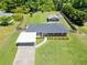 Charming brick home featuring a carport and a spacious, fully fenced yard with an outbuilding and playhouse at 3872 Francis Dr, Powder Springs, GA 30127