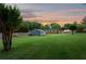 Large backyard showcasing detached garage, lawn and partial fence at 3872 Francis Dr, Powder Springs, GA 30127