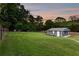 Expansive backyard featuring detached garage, lawn and partial fence at 3872 Francis Dr, Powder Springs, GA 30127