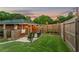 Private fenced backyard with patio area, grill, and string lights at 3872 Francis Dr, Powder Springs, GA 30127
