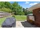 Spacious backyard with lush green lawn, mature trees, and a patio area for outdoor enjoyment at 3872 Francis Dr, Powder Springs, GA 30127