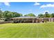 Backyard view showing a sprawling lawn, brick house exterior, and a well-maintained fence at 3872 Francis Dr, Powder Springs, GA 30127