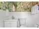 Clean bathroom with floral wallpaper, subway tile, and a stylish mirror at 3872 Francis Dr, Powder Springs, GA 30127