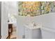 Bathroom featuring floral wallpaper, subway tile, and a bright sink at 3872 Francis Dr, Powder Springs, GA 30127