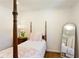 Bright bedroom with four poster bed, full length mirror and classic decor at 3872 Francis Dr, Powder Springs, GA 30127
