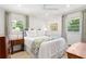 Cozy bedroom featuring lots of natural light, white bedding, and a ceiling fan at 3872 Francis Dr, Powder Springs, GA 30127