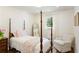 Well-lit bedroom with traditional style bed, a full-length mirror and seating at 3872 Francis Dr, Powder Springs, GA 30127
