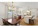 Dining and kitchen combination showing chandelier and white cabinets at 3872 Francis Dr, Powder Springs, GA 30127