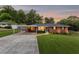 Beautiful exterior view of single story brick house, large front yard, and a carport at 3872 Francis Dr, Powder Springs, GA 30127