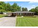 Charming brick home with attached carport and well-kept lawn at 3872 Francis Dr, Powder Springs, GA 30127