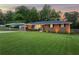 Well-maintained brick home with a lush front lawn, carport, and inviting curb appeal at 3872 Francis Dr, Powder Springs, GA 30127