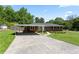 Charming brick home with a well-manicured lawn and a convenient carport at 3872 Francis Dr, Powder Springs, GA 30127