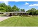 Beautifully landscaped front yard of a single-story brick home with a carport at 3872 Francis Dr, Powder Springs, GA 30127