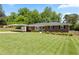 Well-maintained front yard with a classic brick home and a covered carport at 3872 Francis Dr, Powder Springs, GA 30127