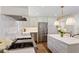Modern kitchen showcasing white cabinets, stainless steel appliances, an island with marble countertops, and pendant lighting at 3872 Francis Dr, Powder Springs, GA 30127