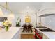 Open kitchen featuring white cabinets, marble countertops, stainless steel appliances, and a view into the living room at 3872 Francis Dr, Powder Springs, GA 30127
