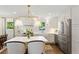 Beautiful kitchen with white cabinets, marble countertops, stainless steel appliances, a red range and an island at 3872 Francis Dr, Powder Springs, GA 30127