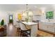 Bright kitchen with white cabinets, stainless steel appliances, marble countertops, and an island with seating at 3872 Francis Dr, Powder Springs, GA 30127