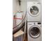 Efficient laundry area with stacked washer and dryer, and modern water heater setup at 3872 Francis Dr, Powder Springs, GA 30127