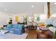 Cozy living room showcasing an open layout to a modern kitchen and dining area at 3872 Francis Dr, Powder Springs, GA 30127