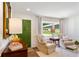 Bright and airy living room with large window, elegant furnishings, and green door at 3872 Francis Dr, Powder Springs, GA 30127