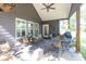 Covered back porch features comfortable seating and an outdoor dining set with views of the backyard at 399 Chestnut St, Social Circle, GA 30025