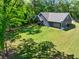 Aerial view of the backyard showcasing the well-maintained lawn, covered porch, and exterior of the home at 399 Chestnut St, Social Circle, GA 30025