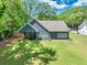 Aerial view of the backyard and porch of a lovely home, complete with a lush, green lawn at 399 Chestnut St, Social Circle, GA 30025
